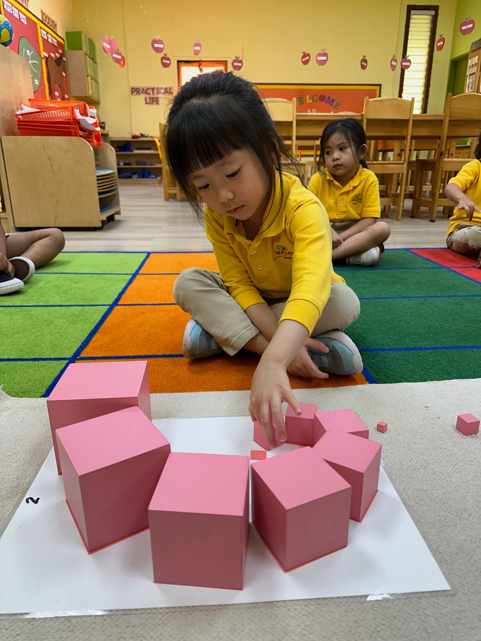 Child building the Montessori pink tower